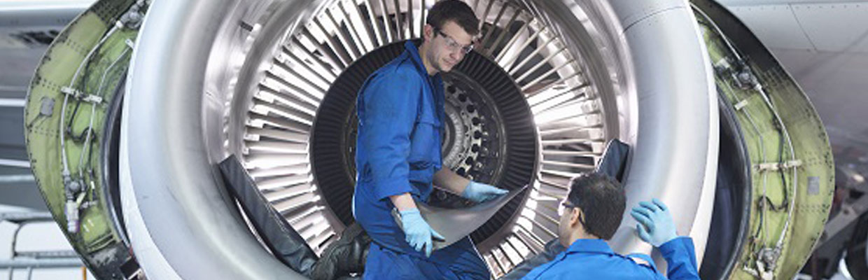 Men fixing airplane engine.
